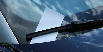 Traffic fine ticket on windshield of a car