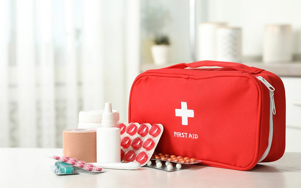 First aid kit with pills on the table