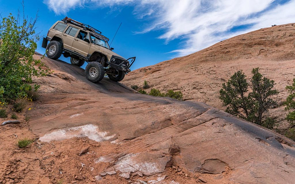 A Jeep Cherokee on a sandstone path