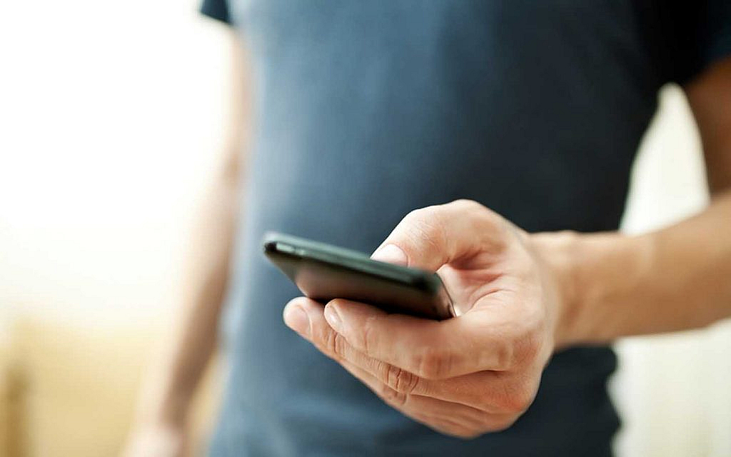A person using phone to monitor tyre pressure