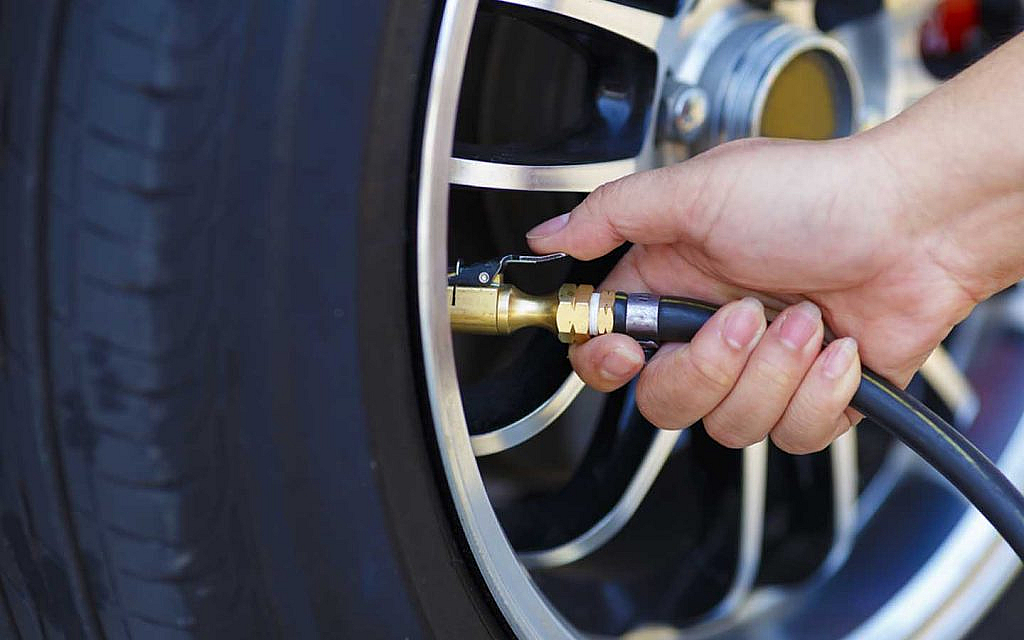 A man filing up air in tyres