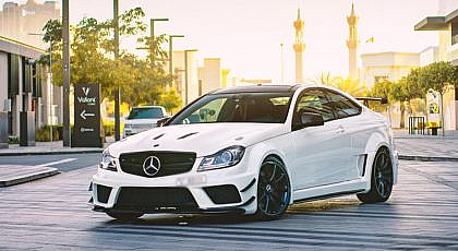 A Mercedes Benz C63 AMG parked on a road in Dubai