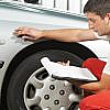 Mechanic inspecting a car’s body