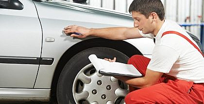 Mechanic inspecting a car’s body