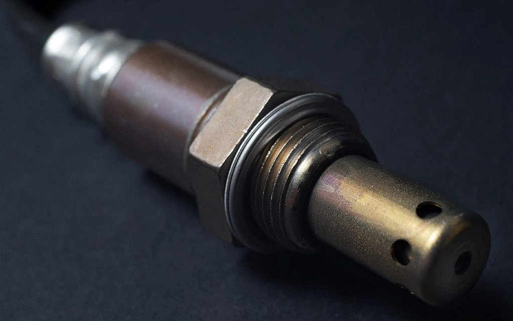 A close up of a car oxygen sensor