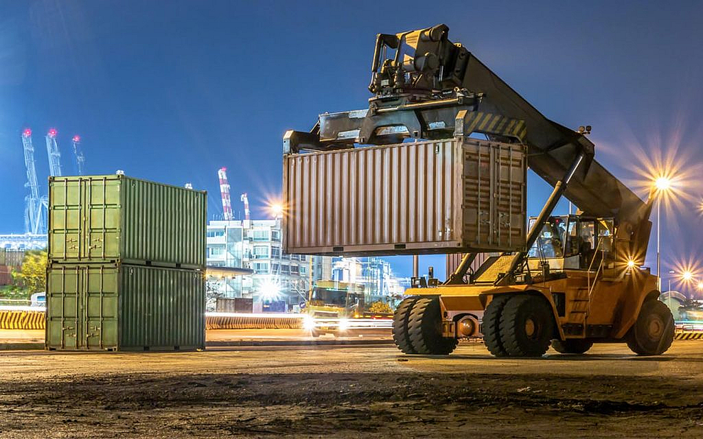 Heavy forklift handling huge boxes in a logistic area