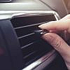 A woman checking the Symptoms of a Bad Blower Motor Resistor