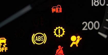 Various signs on car dashboard including the ABS light