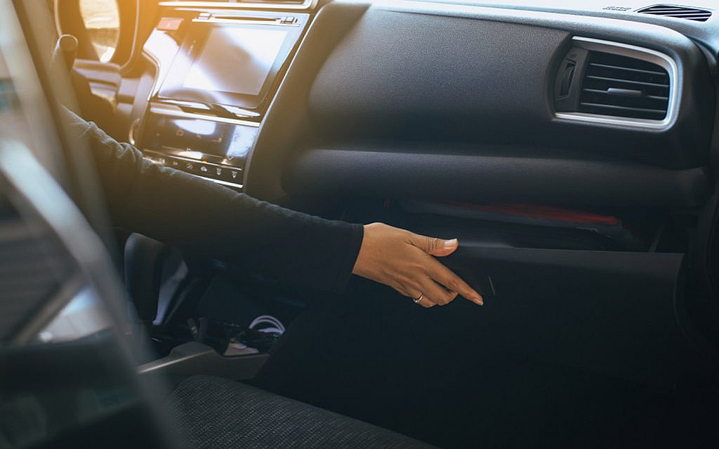 woman opening glove compartment 