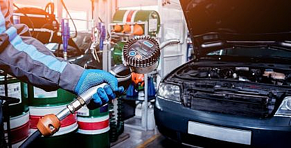 Man checking car fluid levels while car tuning