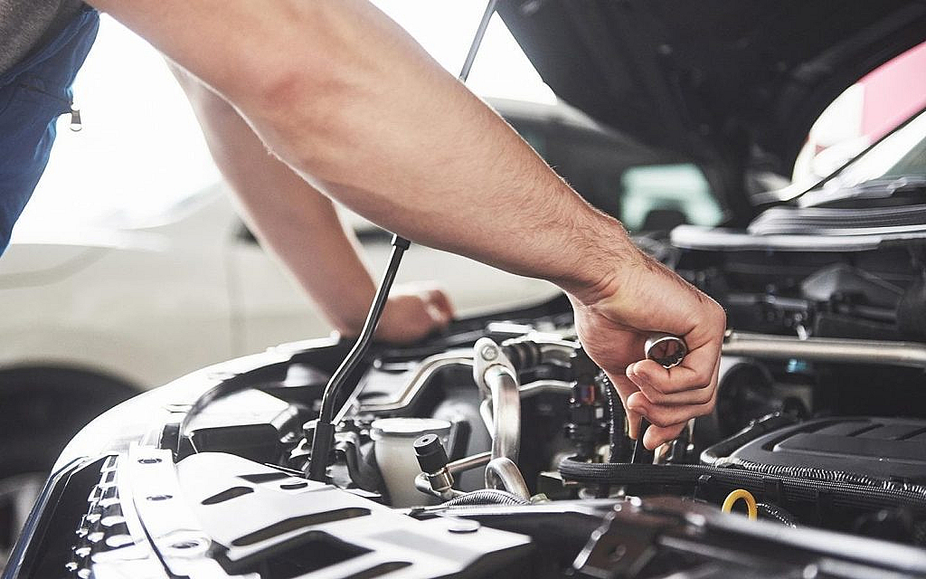 Mechanic checking a car’s engine 