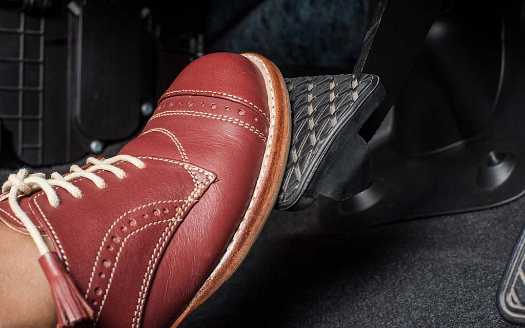 foot pressing on car brake