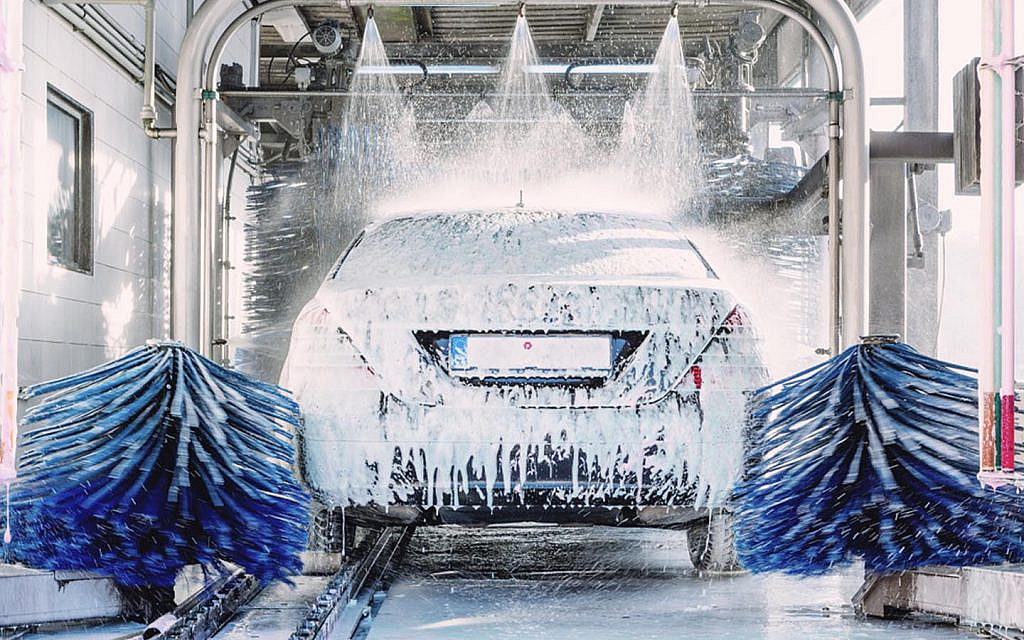 A car being automatically washed in a garage