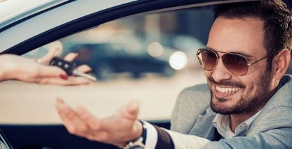 Man taking keys from a car rental in Ajman