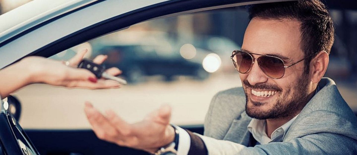 Man taking keys from a car rental in Ajman