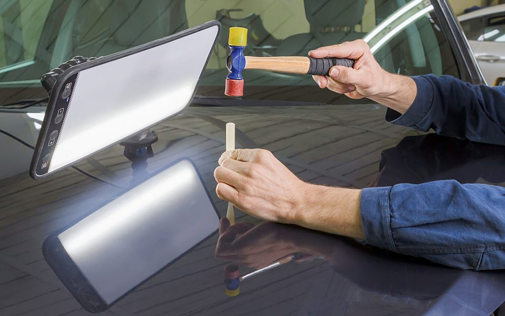 A person doing dent removal service