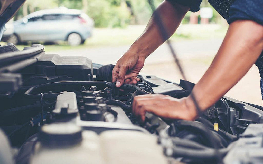 A man changing a car’s engine