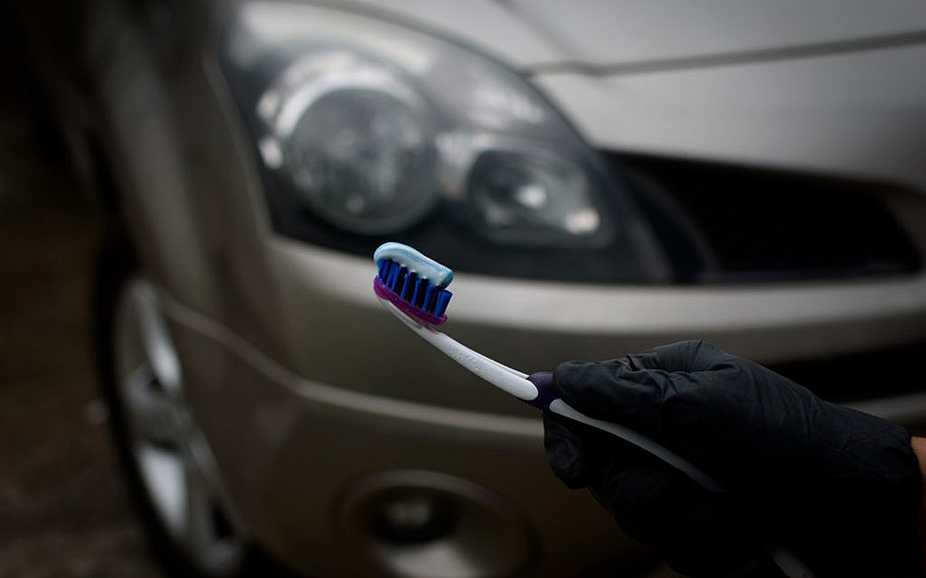 Removing cloudiness from car’s headlights by using toothpaste