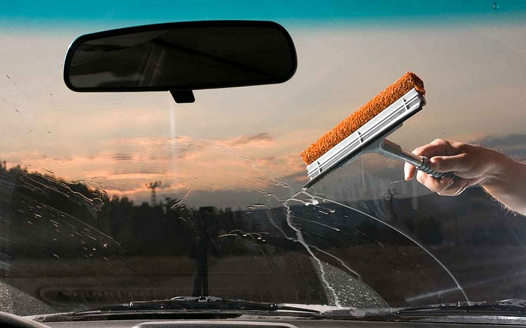 Car windshield being washed