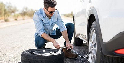 changing flat tyre and installing car spare tyre