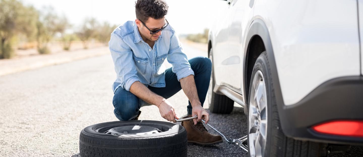 changing flat tyre and installing car spare tyre