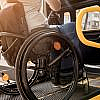 Man in a wheelchair on a ramp getting inside a wheelchair accessible transportation vehicle