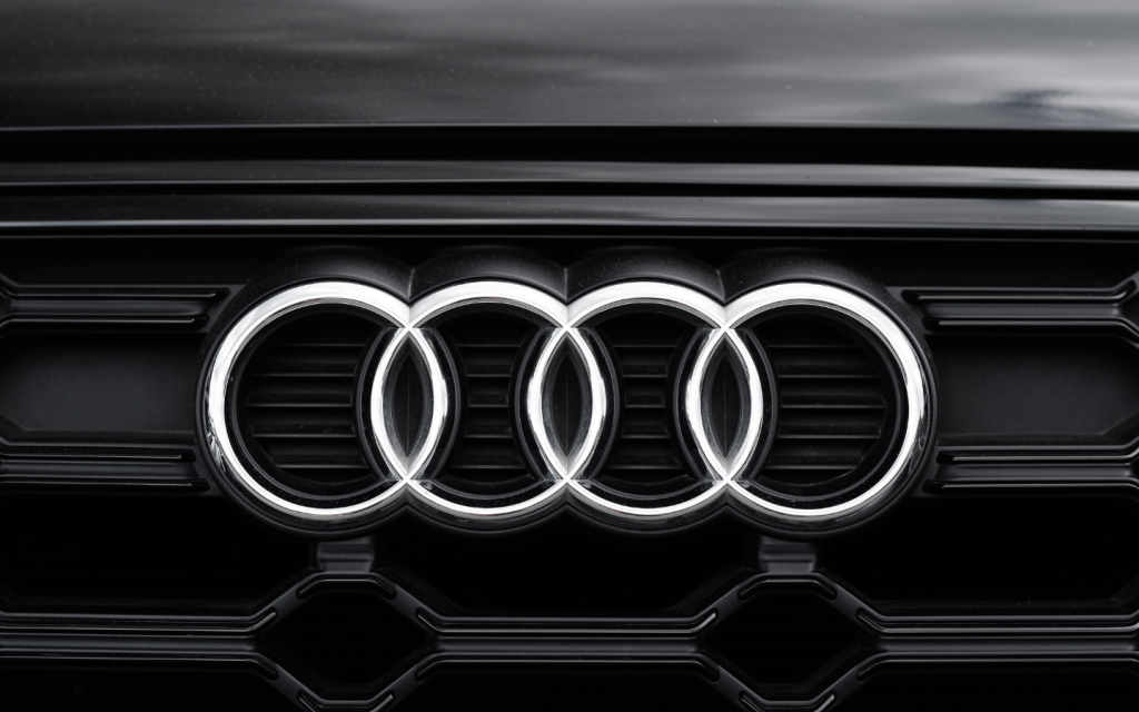 Silver Audi logo on a black car