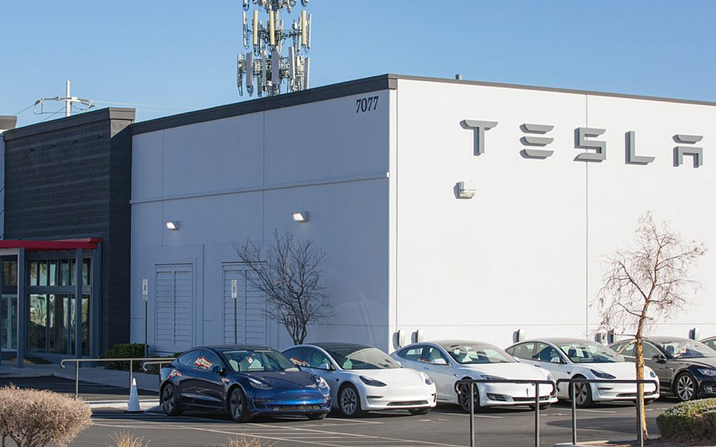Tesla models parked outside a Tesla dealership