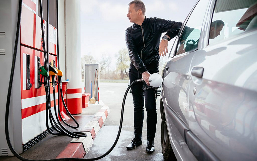 Refueling  car's tank at the fuel station.
