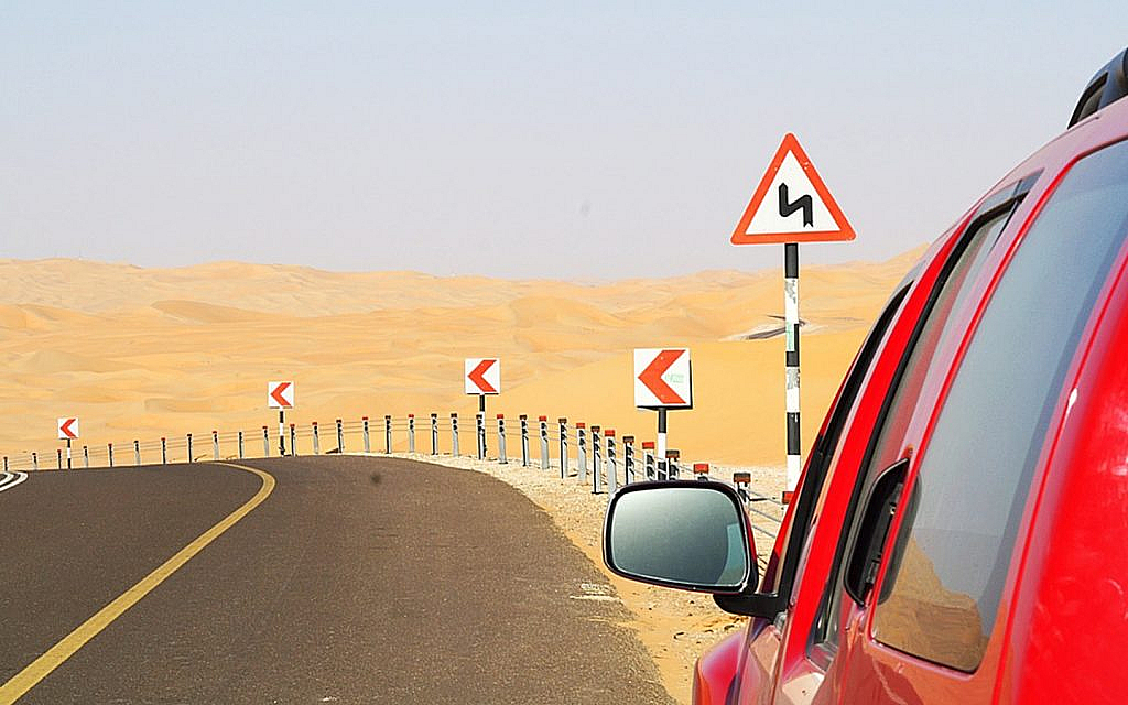 Desert drive and road sign Liwa dunes Abu Dhabi