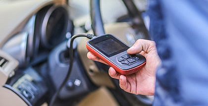 man checking car diagnostic codes on a Diagnostic Test Machine