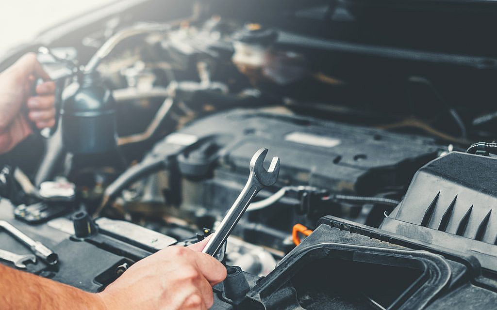 A person working on a car’s engine