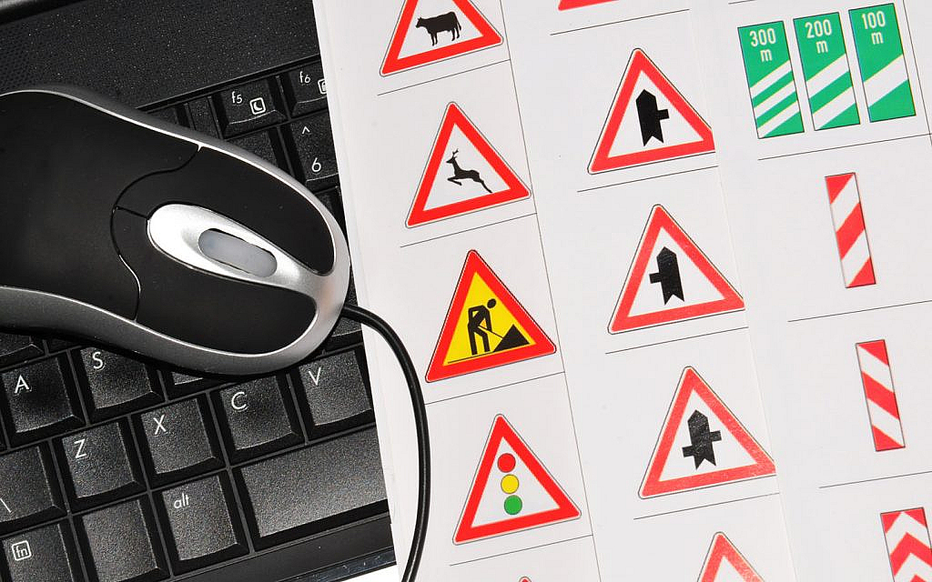 Driving licence online with computer and traffic signs