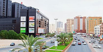 Ajman traffic fine discount. Cars commuting on Modern Avenue, Ajman
