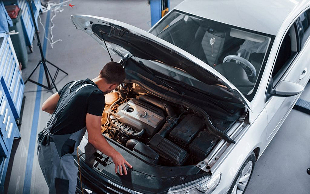 Expert is checking the car engine