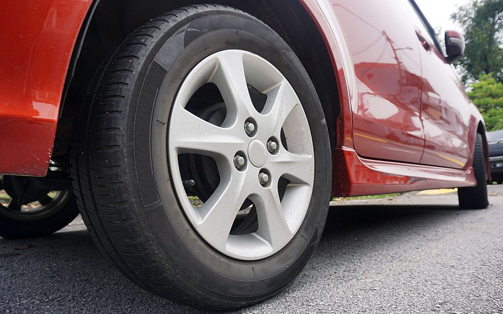 A car with new tyres parked on the road