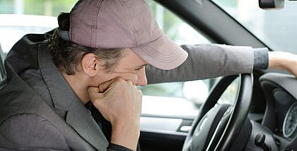 Bored man thinking how he can eliminate boredom during ev recharge