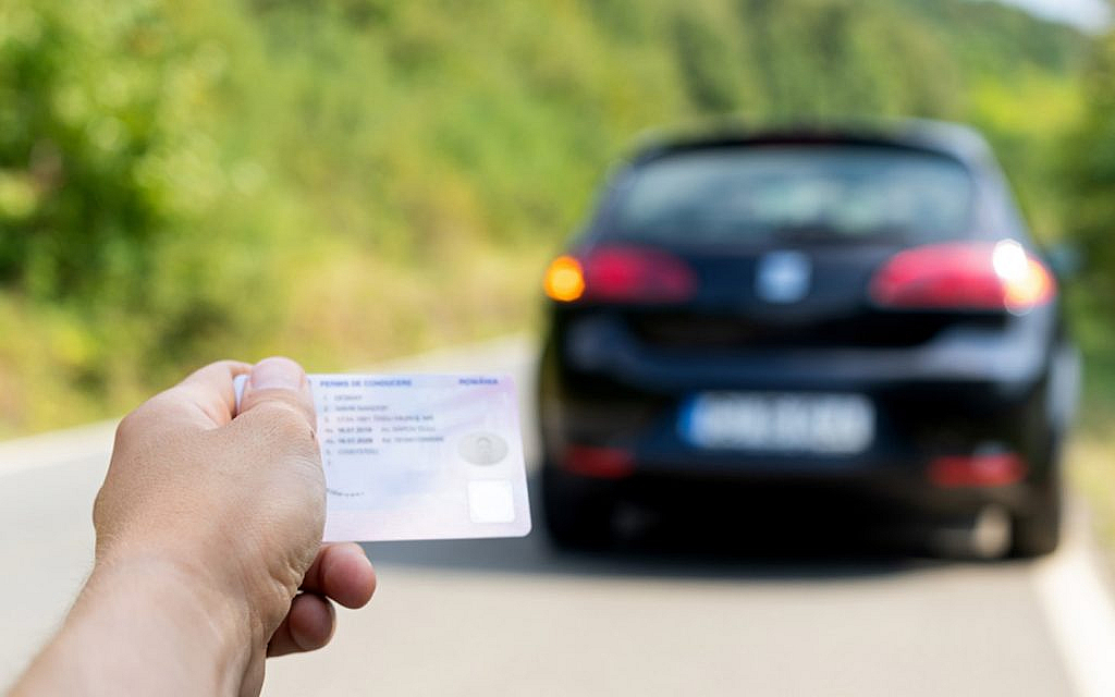 A man holding his new driving licence