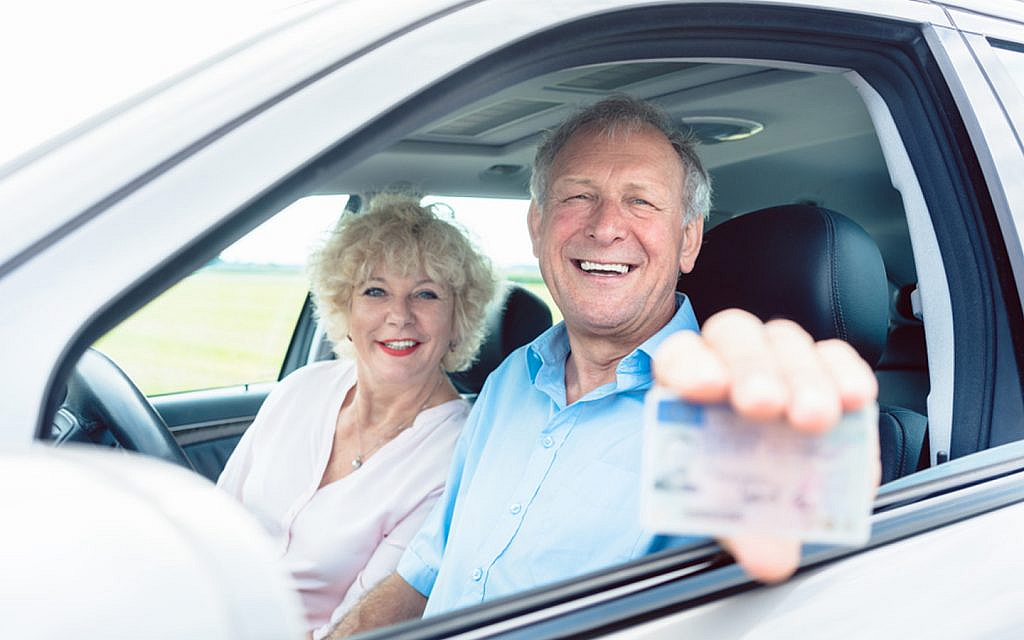 A couple showing their driving licence