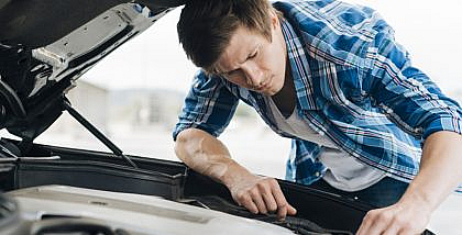 A man is checking the bad evaporative emission control canister