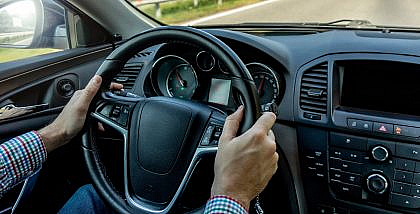 man turning a hard steering wheel