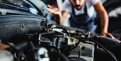 A man is fixing a seized car engine