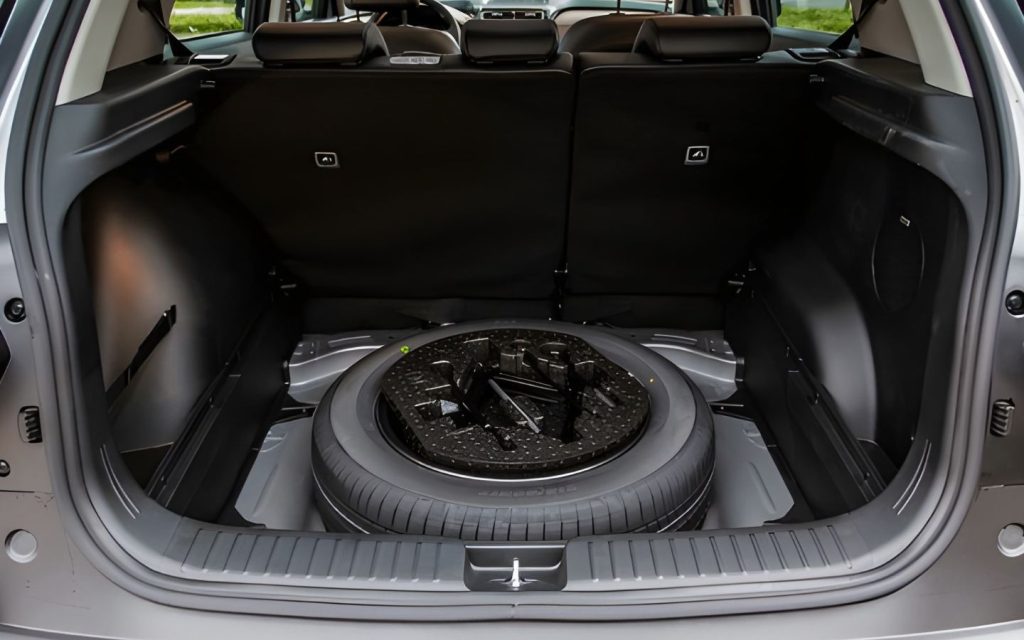 Check the area below the spare tyre in the boot, where the VIN may be stamped.