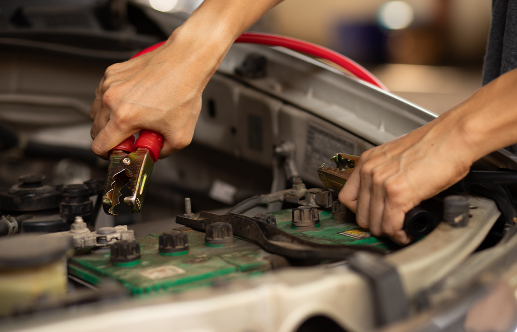 a person is checking battery terminals 