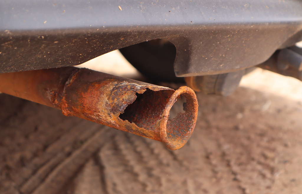 A broken exhaust pipe of a car