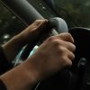 driver gripping steering wheel