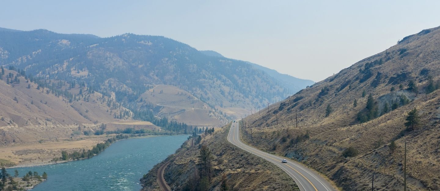 car driving between mountains