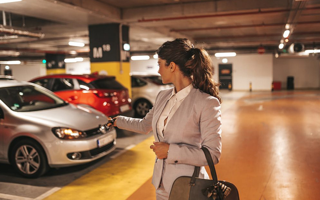 woman trying to unlock her car through remote car key