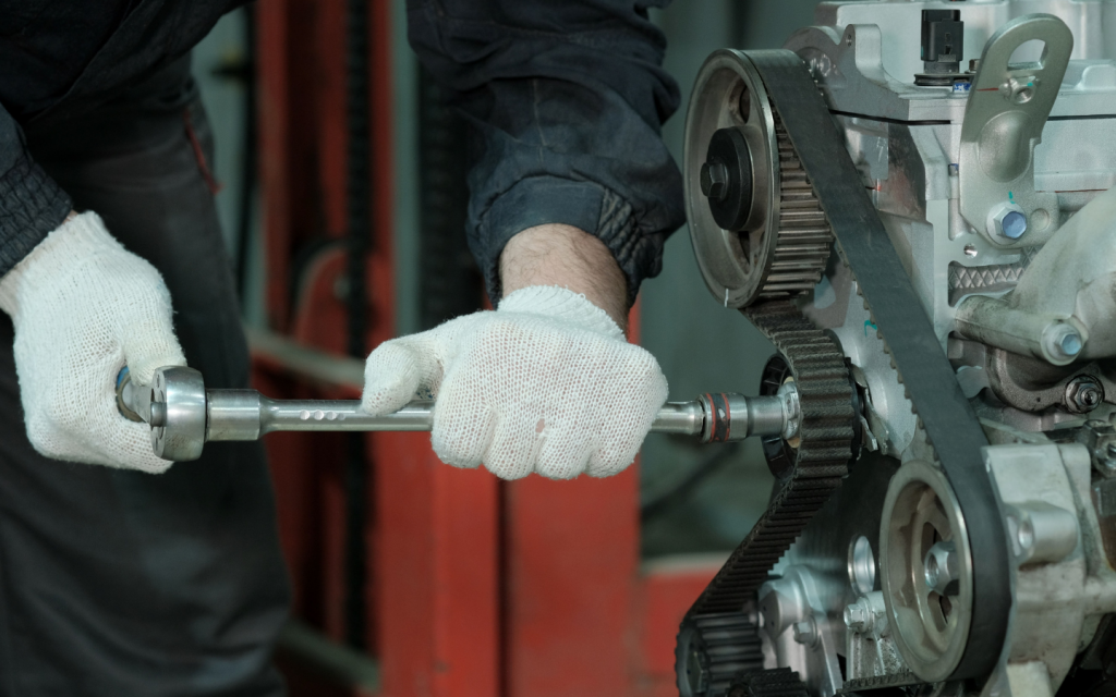 A mechanic with a wrench repairing engine