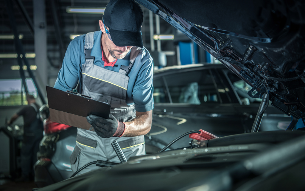 A mechanic with a checksheet checking engine 